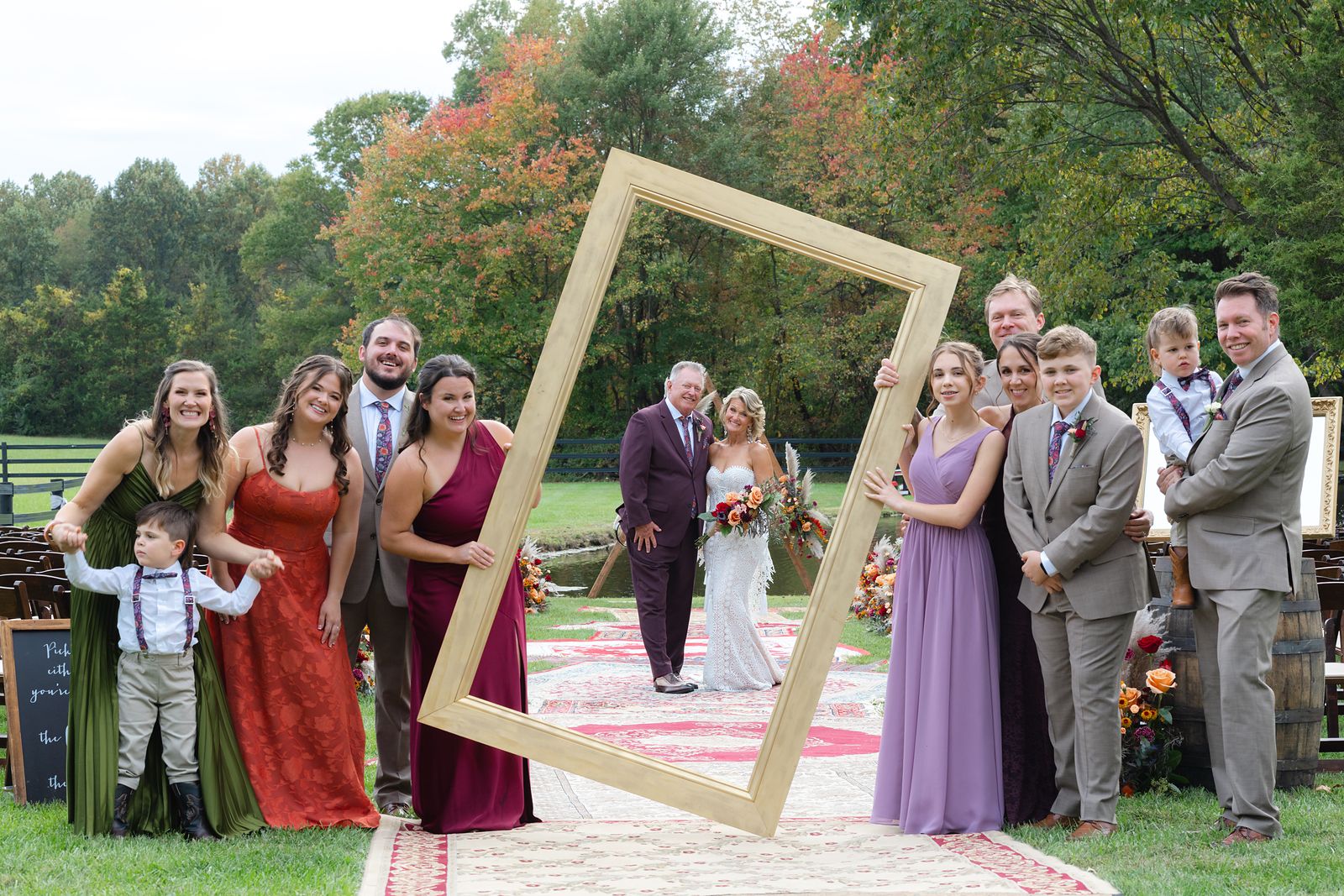 Shannon and Brian's children and grandchildren in a giant picture frame at the ceremony site