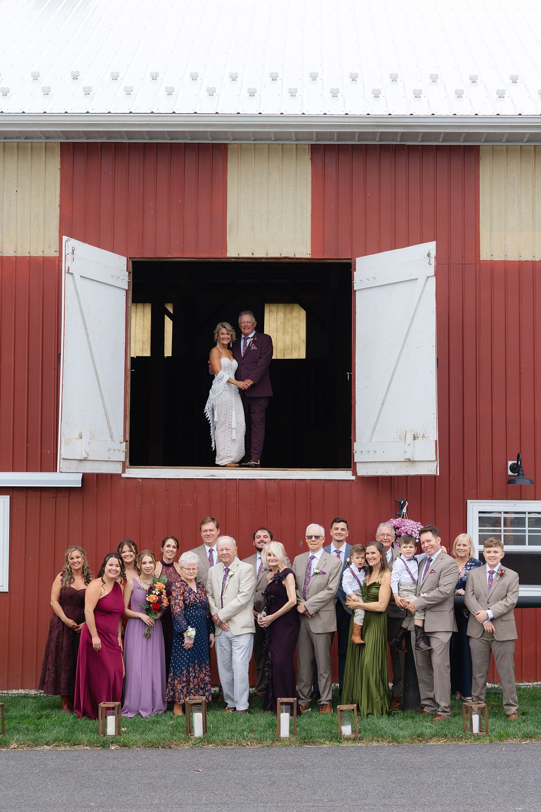 The family gathered below the hay loft at the barn, with Shannon and Brian in the loft doors