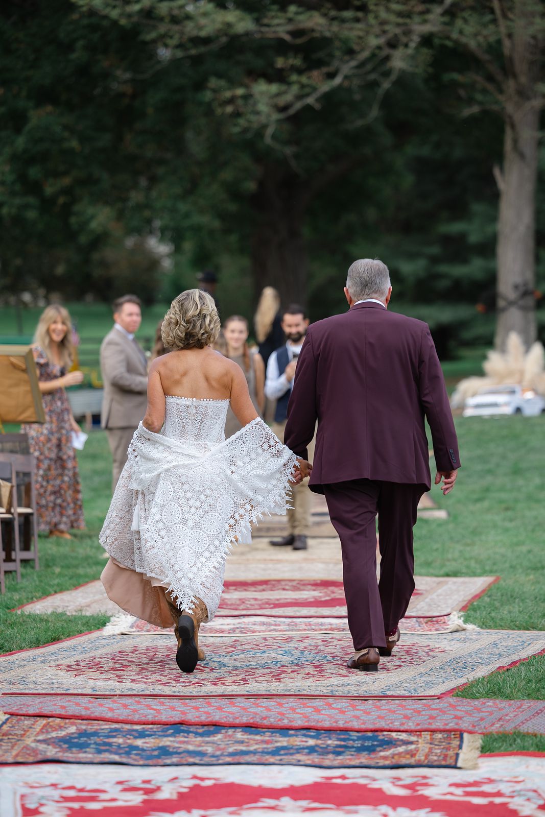 Shannon and Brian walking back up the vintage rug aisle