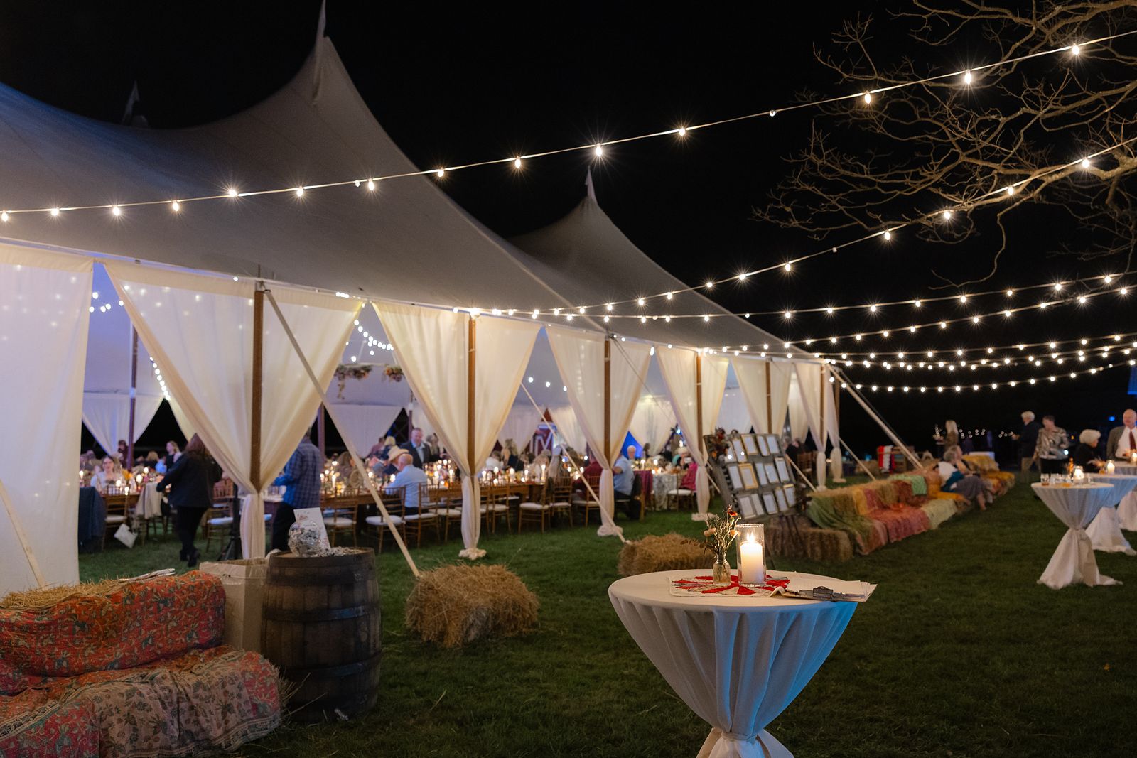The sailcloth tent lit up at night on the farm