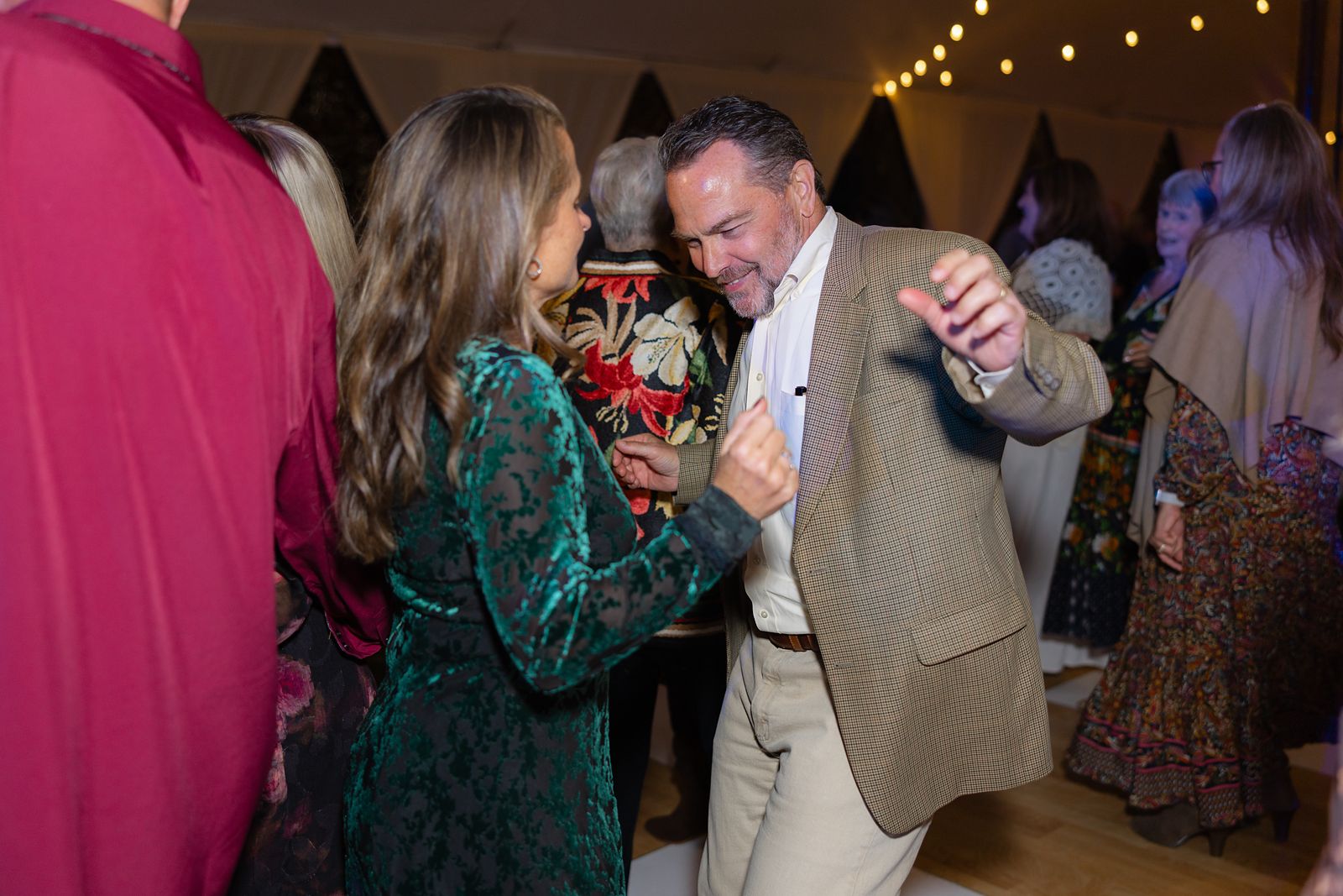 Guests dancing under the string lights
